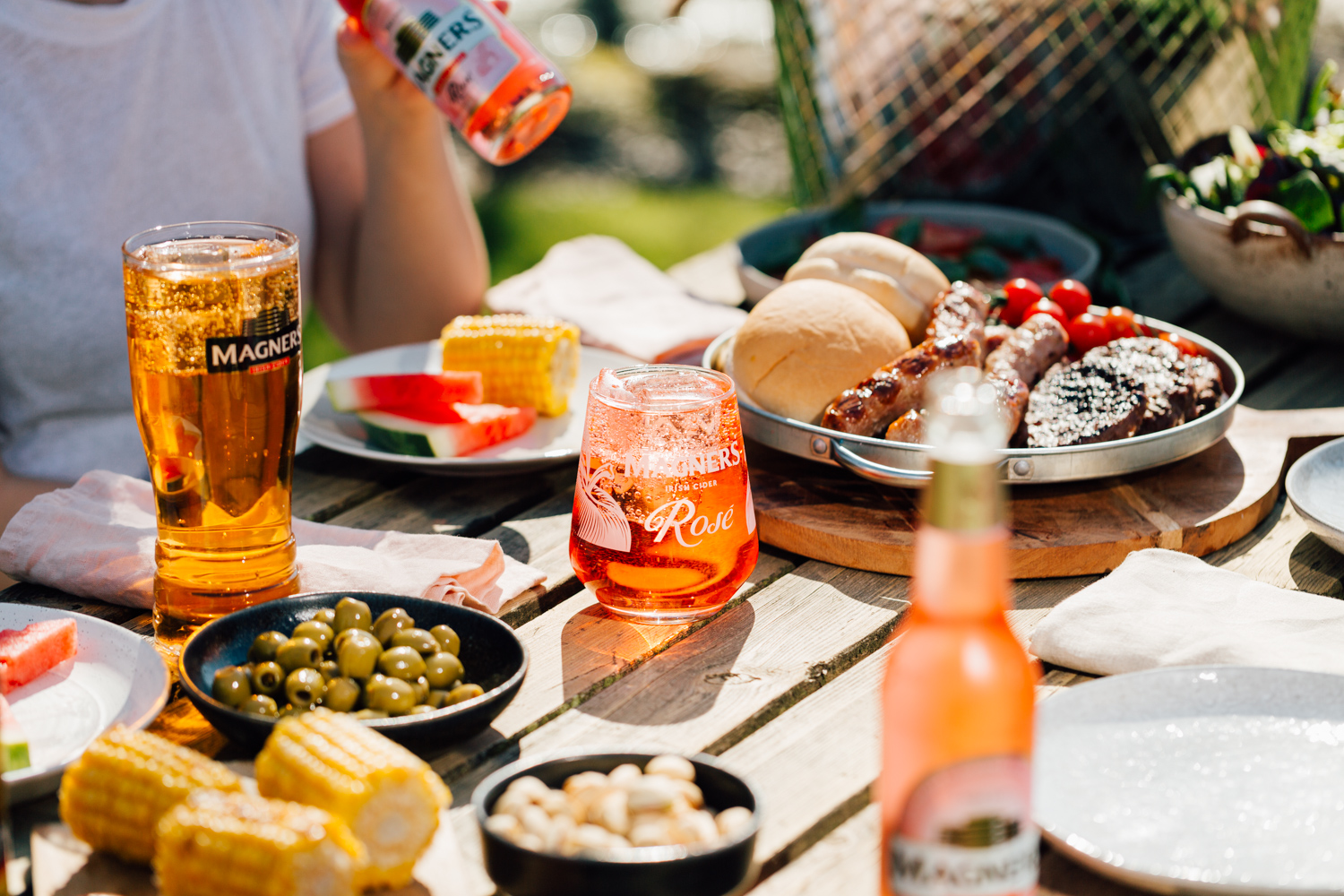 Glass of Magners Rose on a picnic table with food