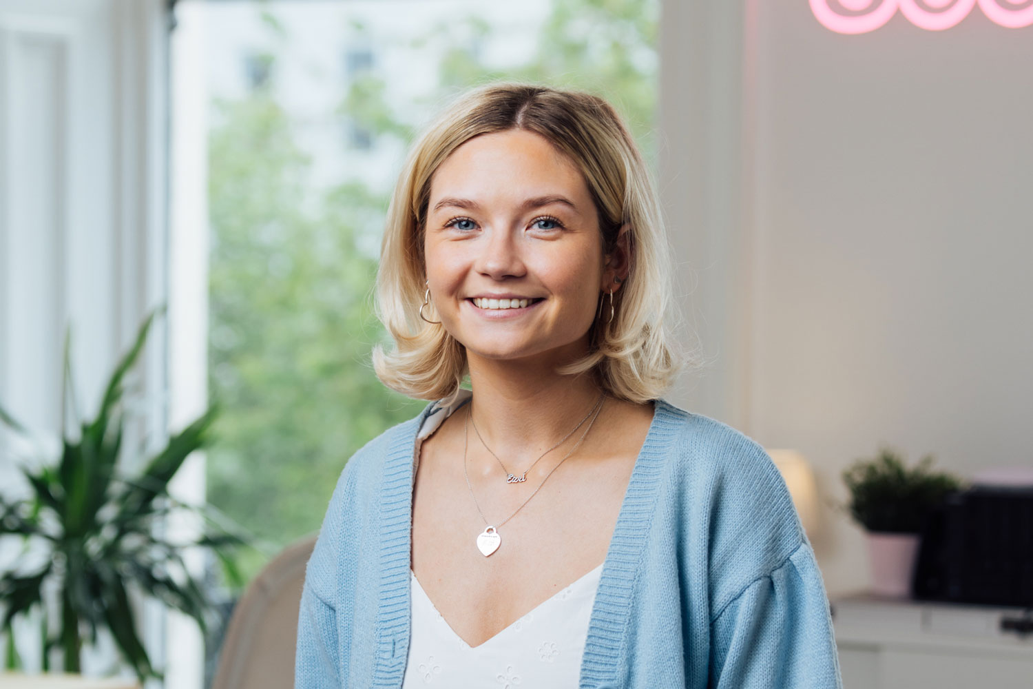 Headshot photographer Glasgow of blonde woman smiling in office