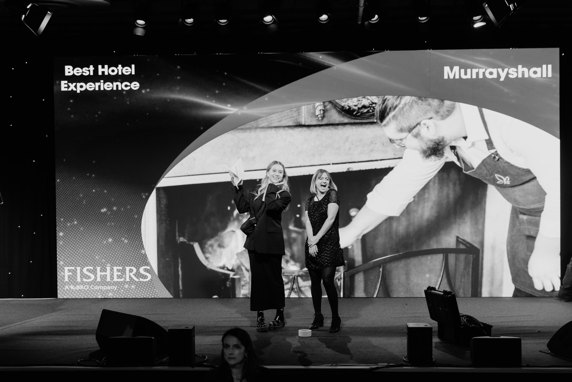 Behind-the-scenes photograph at the Scottish Thistle Awards Central & East Region in Edinburgh, showing two women rehearsing on stage under event lighting before the ceremony.